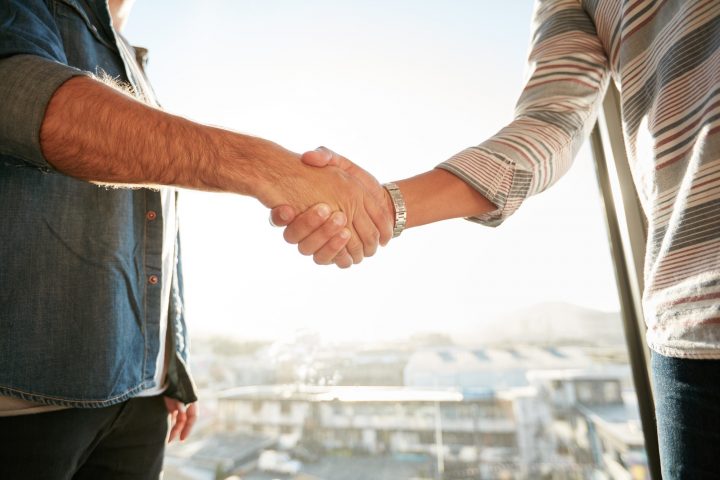 Businesspeople shaking hands in office